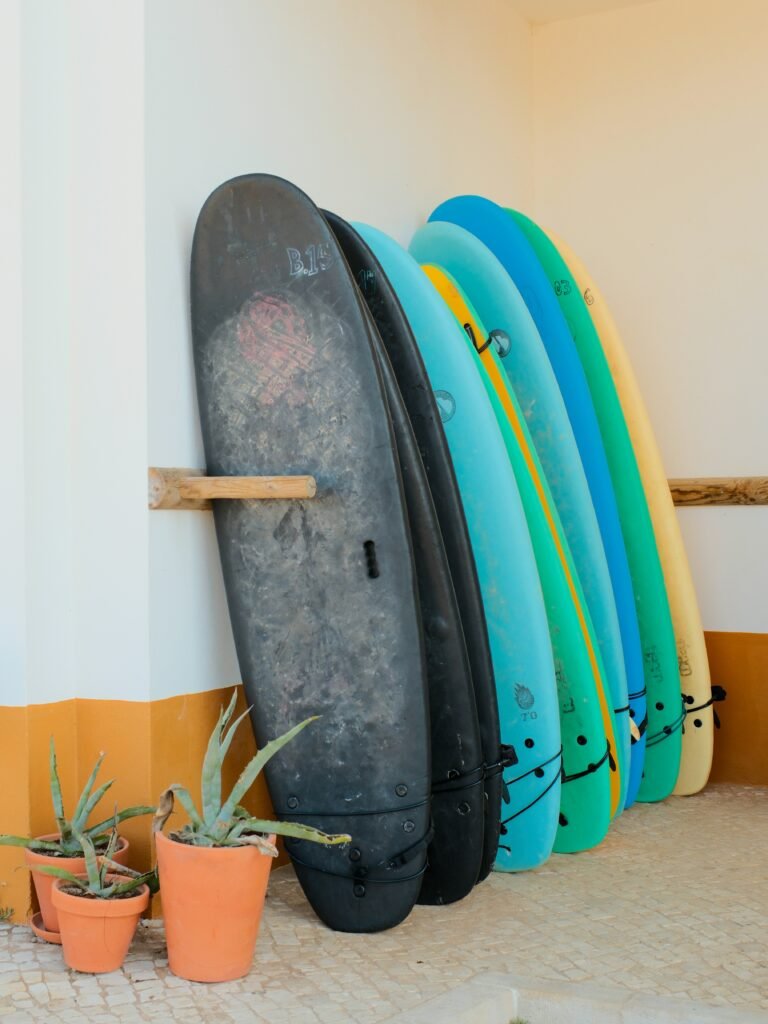 Row of colorful surfboards leaning against wall